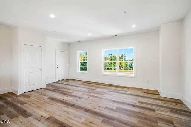 a view of room with window and wooden floor