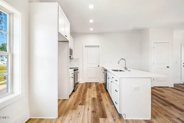 a spacious bathroom with a sink and a mirror