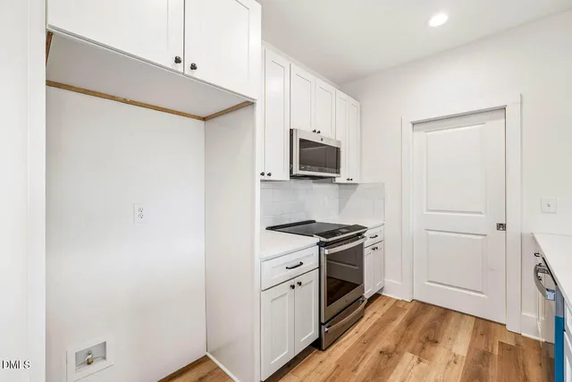 a kitchen with a stove microwave and sink
