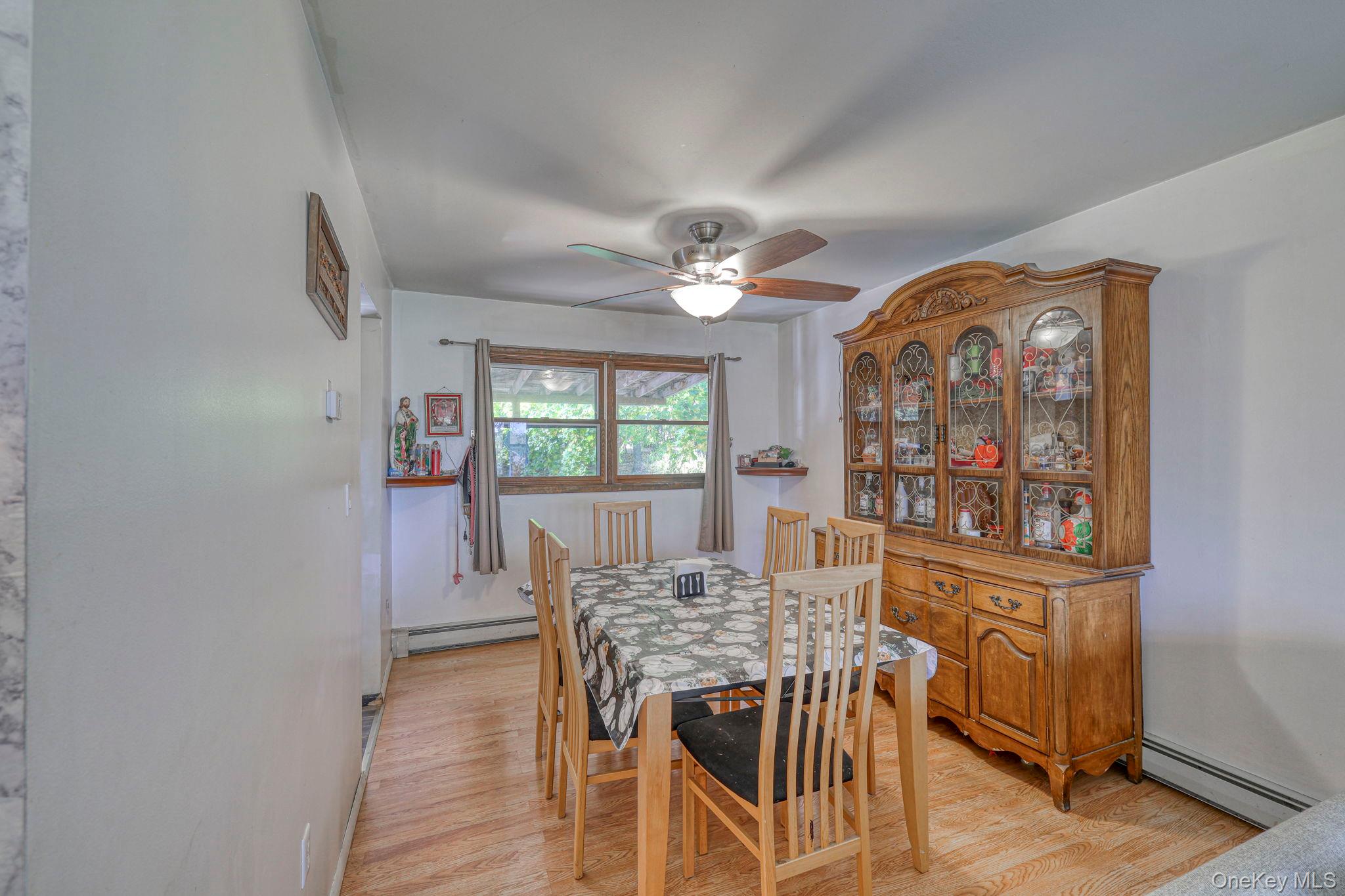 191 Mills Road Walden, NY 12586 - Photo 12 of 27 Dining space with light wood finished floors, baseboard heating, and ceiling fan