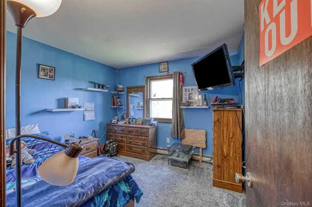 a living room with furniture a flat screen tv and kitchen view