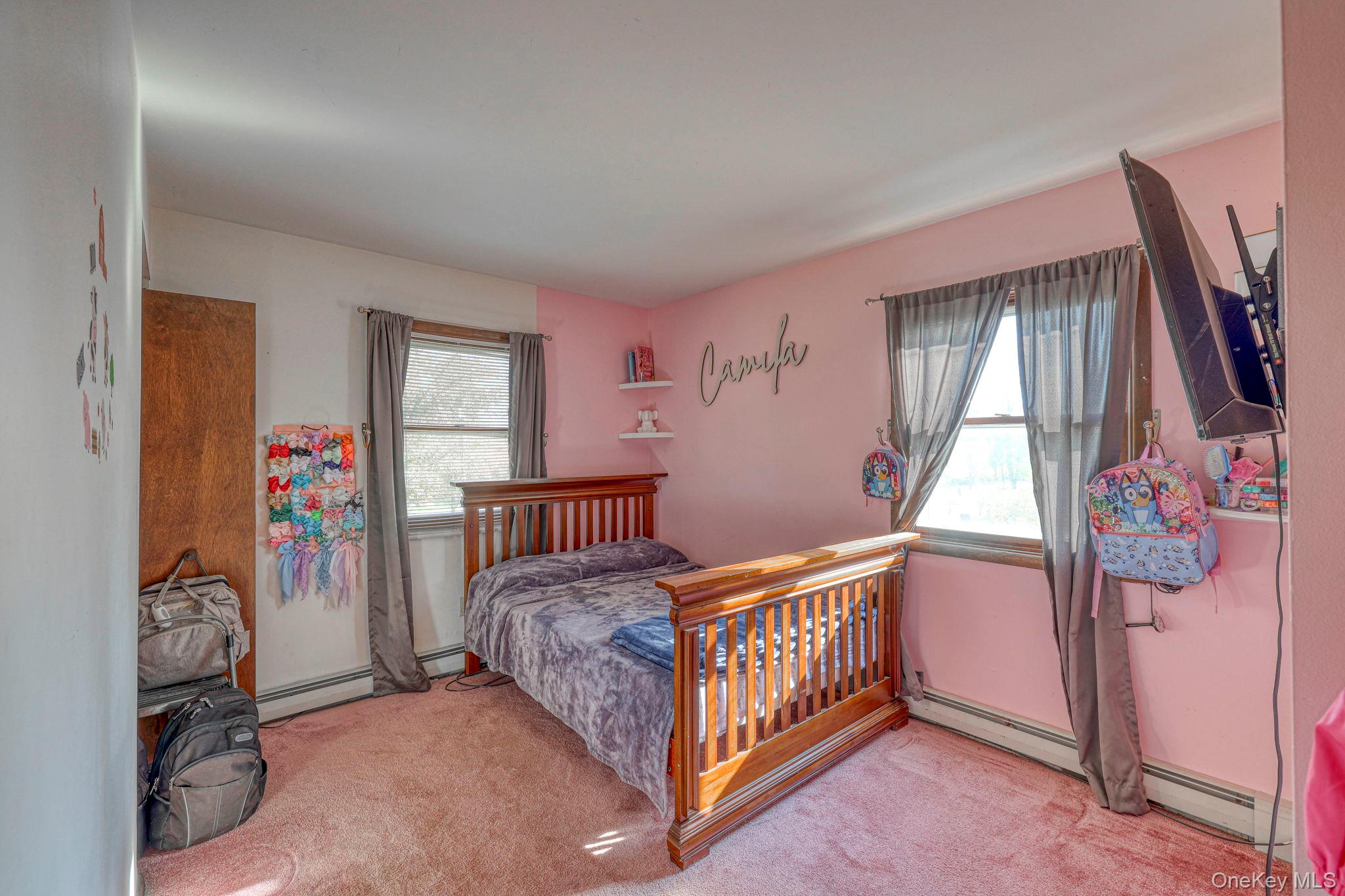 191 Mills Road Walden, NY 12586 - Photo 17 of 27 Bedroom featuring carpet flooring, multiple windows, and a baseboard radiator