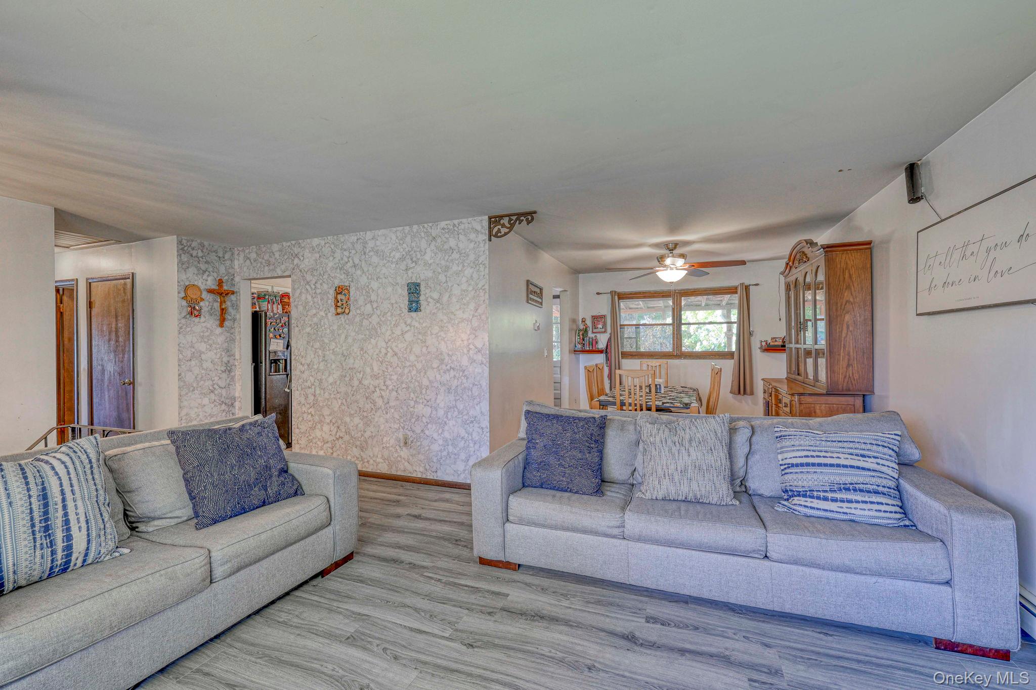 191 Mills Road Walden, NY 12586 - Photo 10 of 27 Living room featuring wallpapered walls, wood finished floors, and a ceiling fan