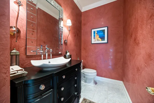 a spacious bathroom with a granite countertop sink and a large mirror