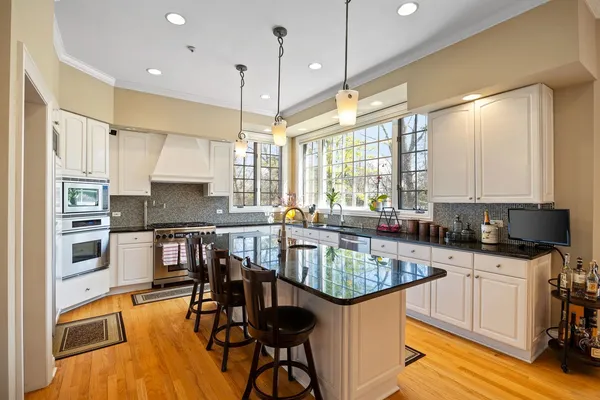 a kitchen with granite countertop a sink a stove and a counter space