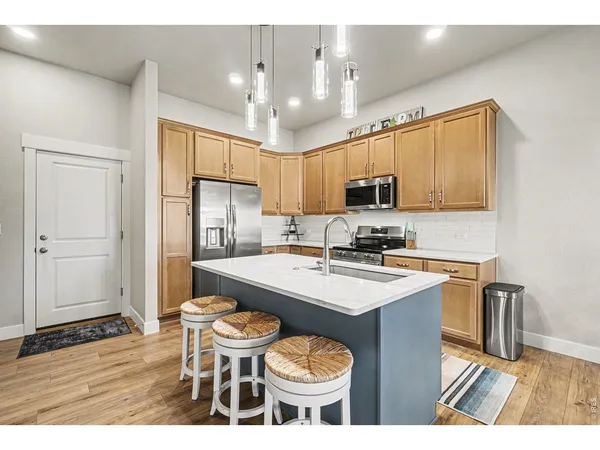 a kitchen with a sink stove and refrigerator