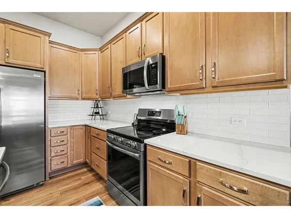 a kitchen with stainless steel appliances granite countertop a refrigerator sink and cabinets