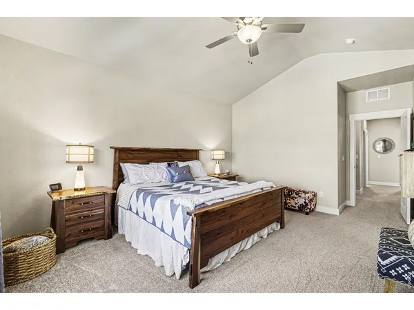 a spacious bedroom with a bed and window