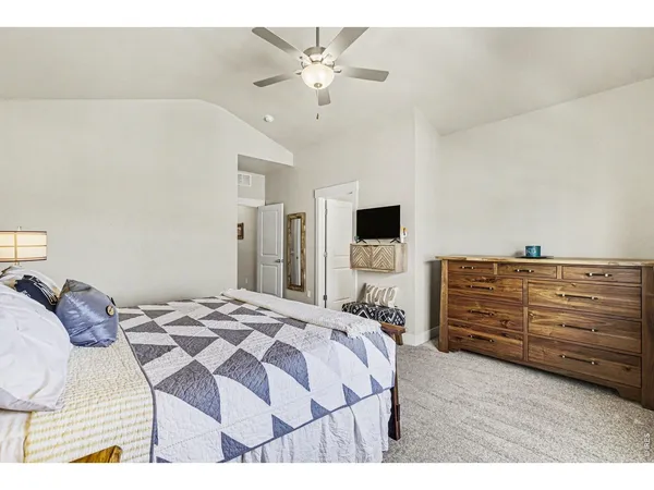 a bedroom with bed and a chandelier