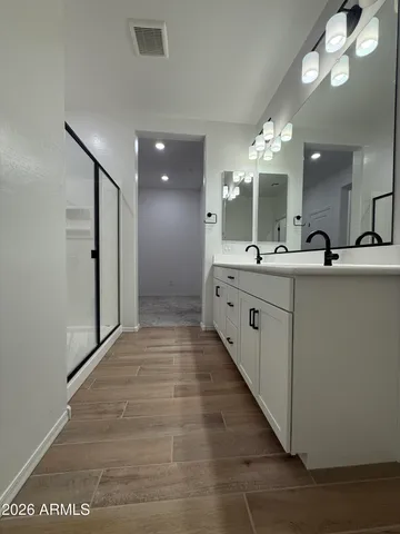 an empty room with a ceiling fan and window