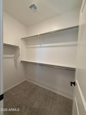 a bathroom with a double vanity sink a toilet a mirror and shower