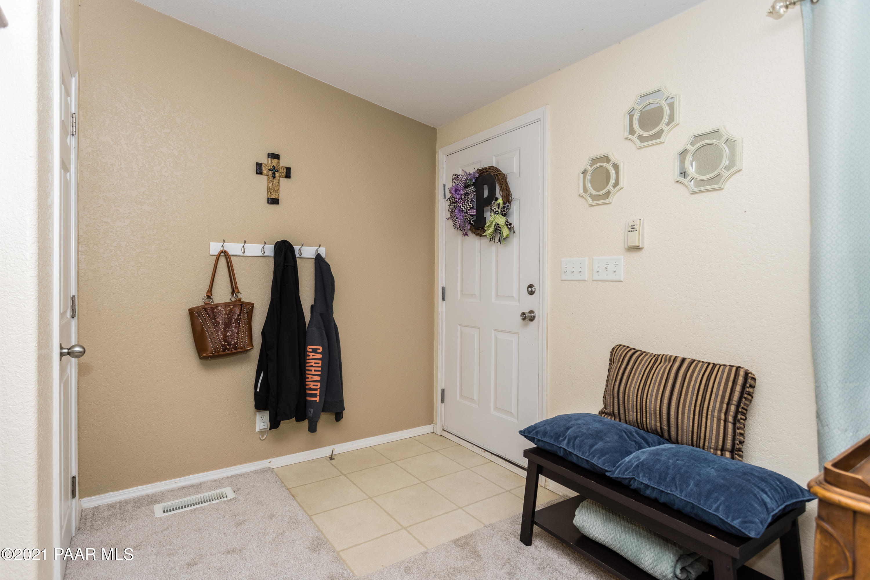 25355 North Mitchell Road Paulden, AZ 86334 - Photo 8 of 37 a hallway with a couch and a white door