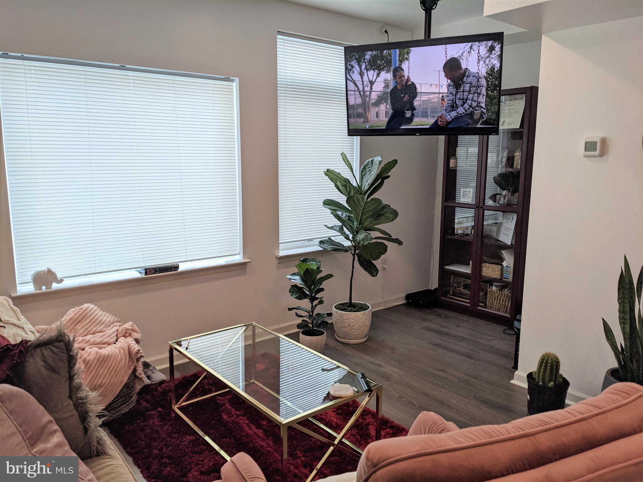 6615 Ridge Avenue, Unit 102 Philadelphia, PA 19128 - Photo 6 of 12 a living room with furniture and wall paintings