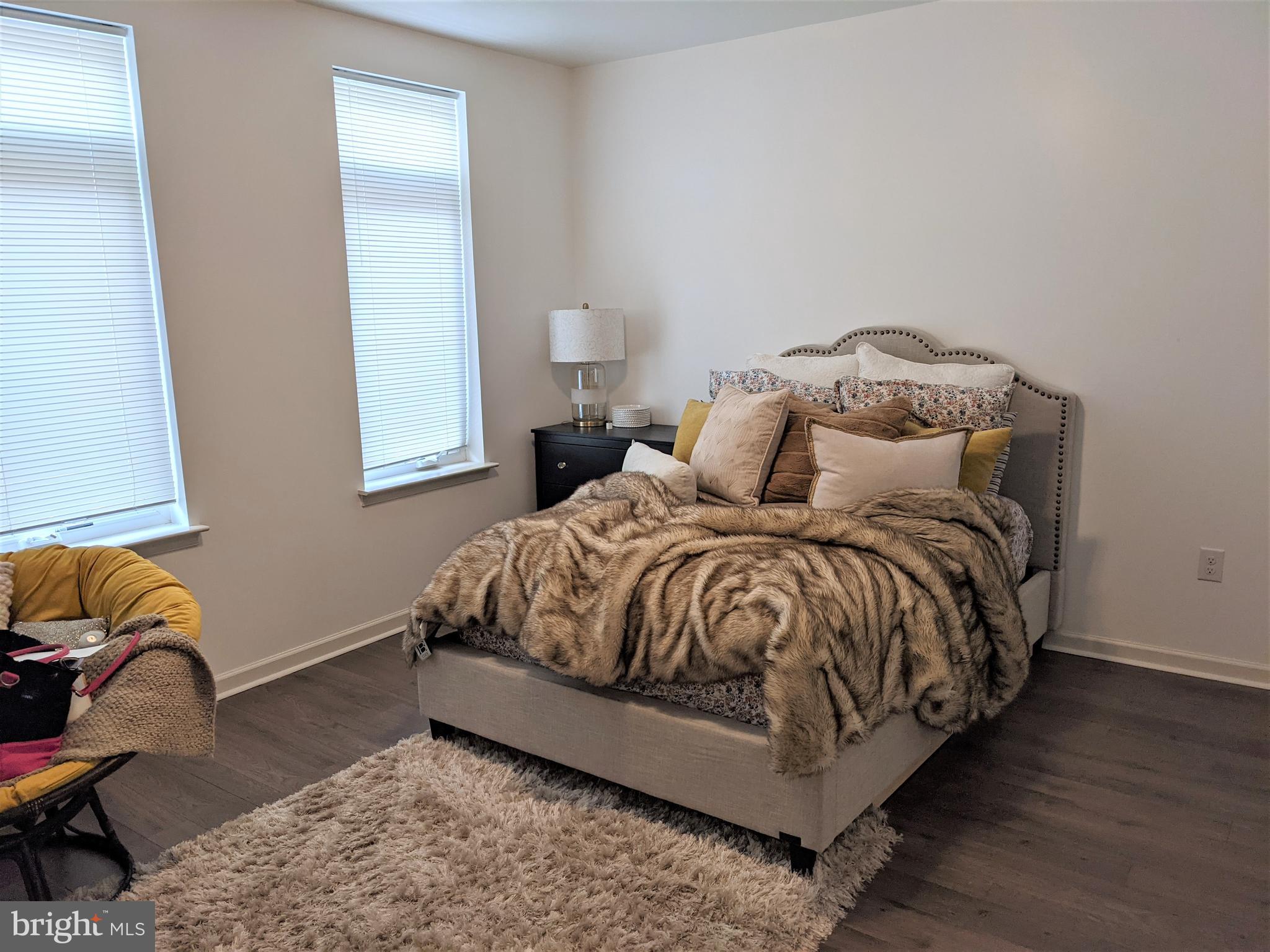 6615 Ridge Avenue, Unit 102 Philadelphia, PA 19128 - Photo 7 of 12 a bedroom with a bed and lamp