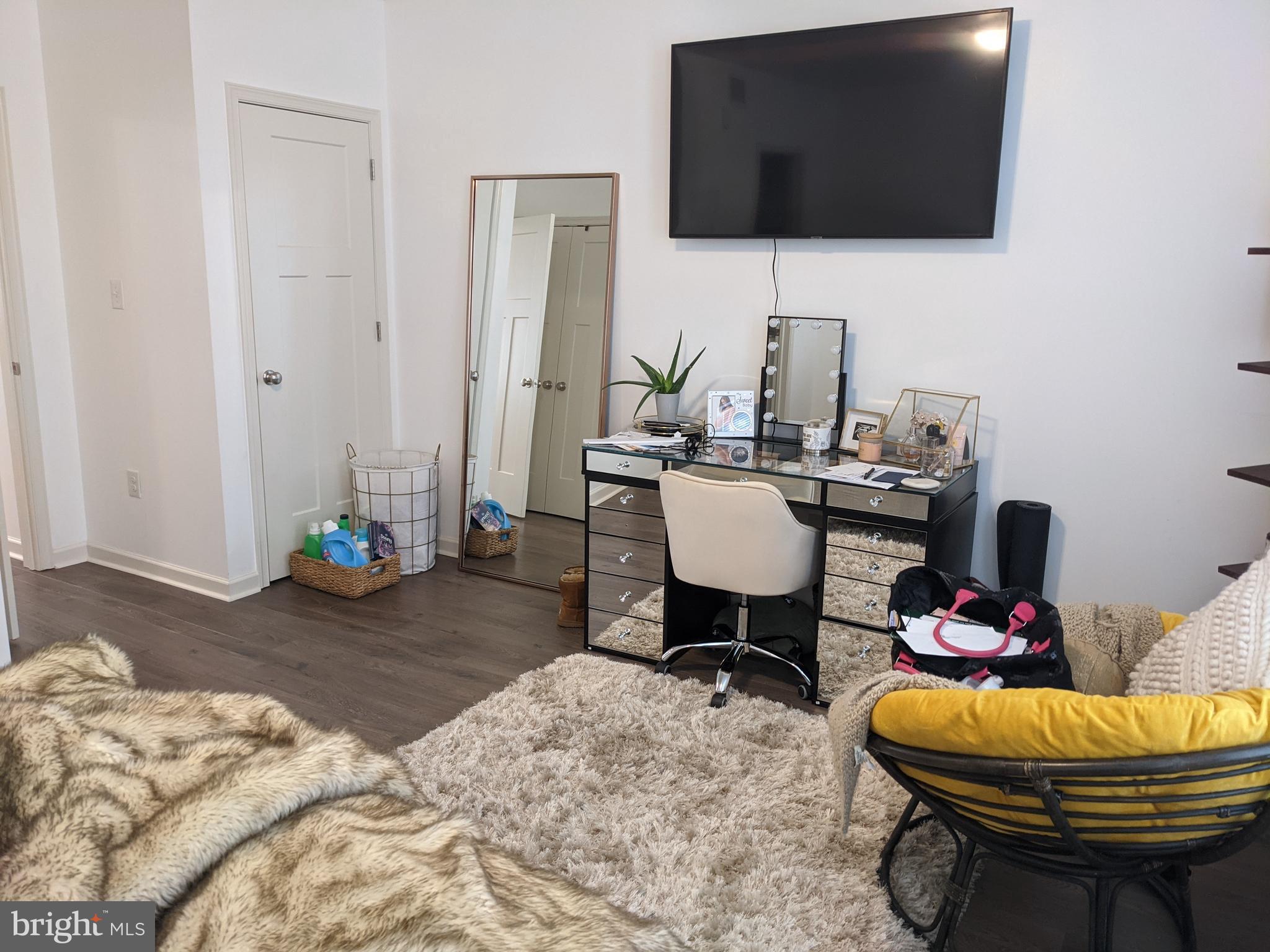 6615 Ridge Avenue, Unit 102 Philadelphia, PA 19128 - Photo 9 of 12 a living room with furniture and a flat screen tv
