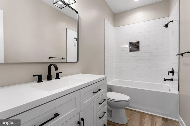 a bathroom with a toilet a sink and a bathtub