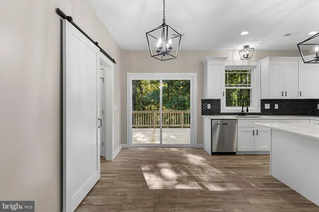 a large kitchen with a large window appliances and cabinets