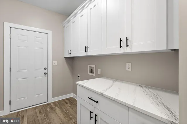 a view of a room with wooden floor