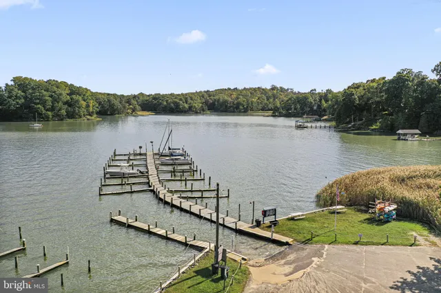 a view of a swimming pool with a yard and outdoor seating
