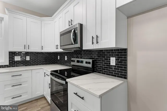 a close view of a stove a microwave and cabinets