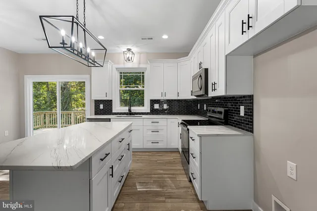 a kitchen with stainless steel appliances granite countertop a sink and stove