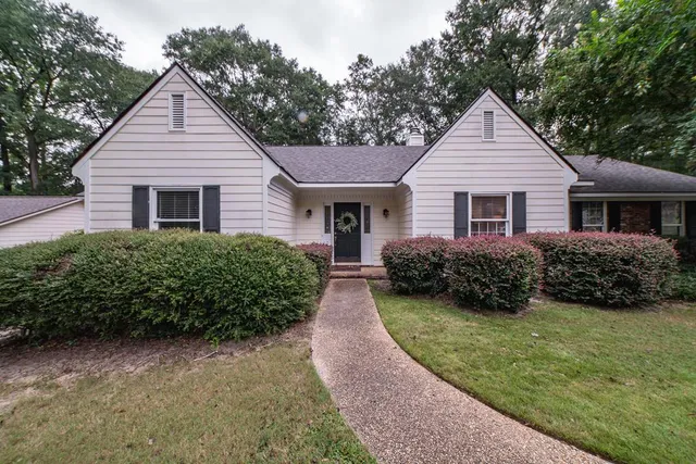 a front view of house with yard and green space