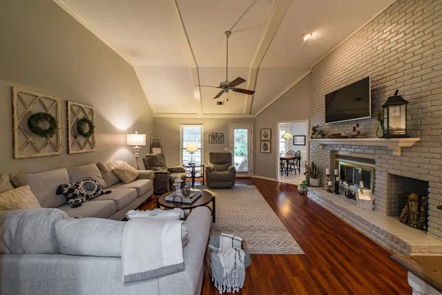 a living room with furniture and wooden floor