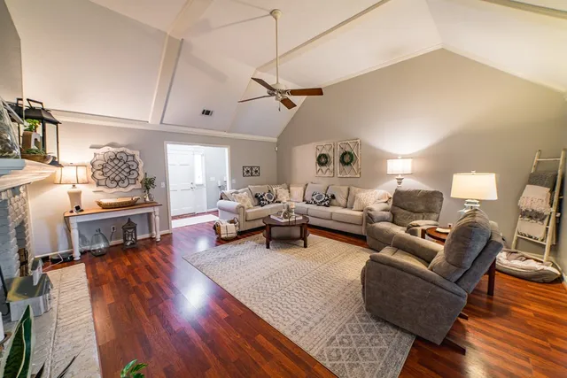 a living room with furniture a flat screen tv and a fireplace