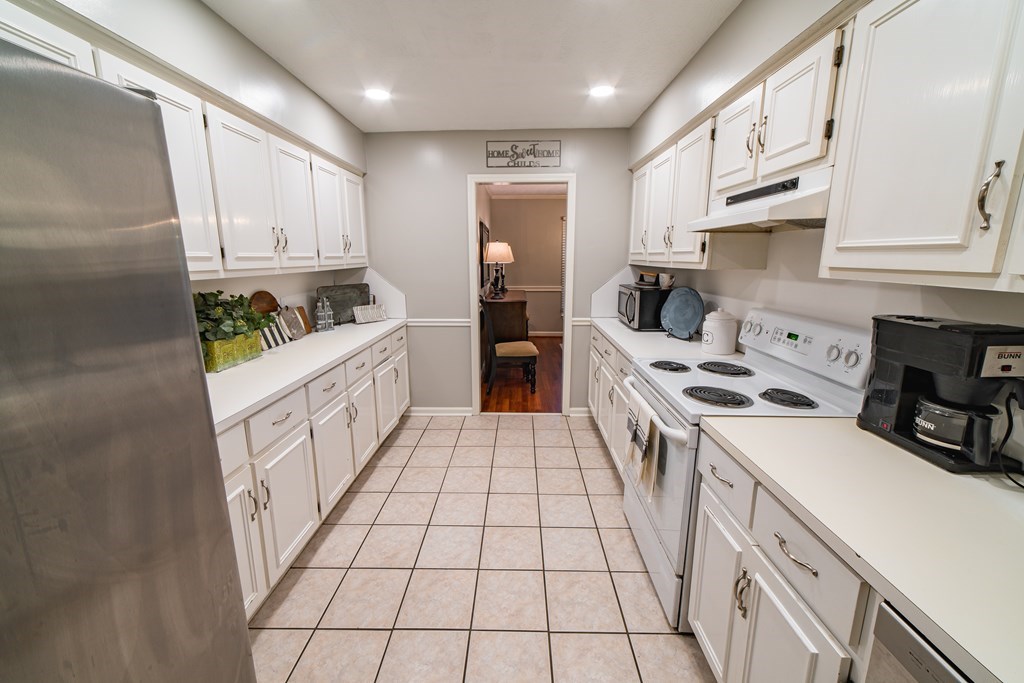 9 Conisburgh Court Columbus, GA 31907 - Photo 23 of 46 a kitchen with stainless steel appliances a white cabinets and a stove top oven