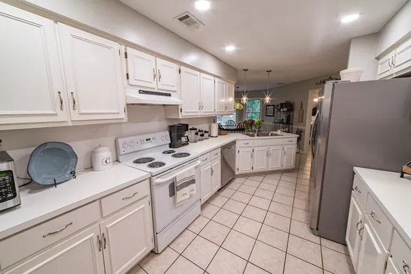 a kitchen with a sink and refrigerator