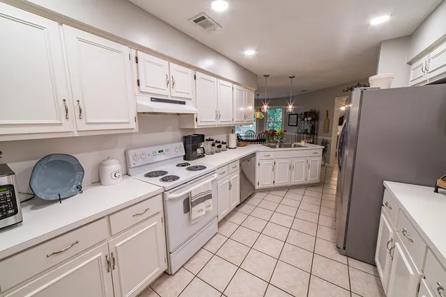 a kitchen with a sink and refrigerator