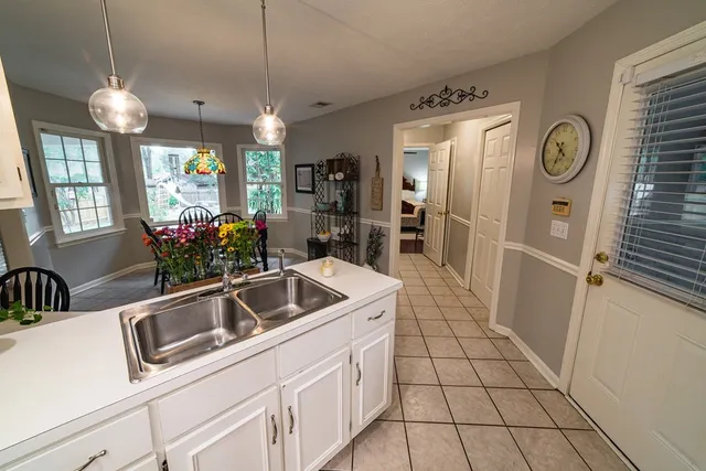 a view of a dining room with furniture a chandelier and wooden floor