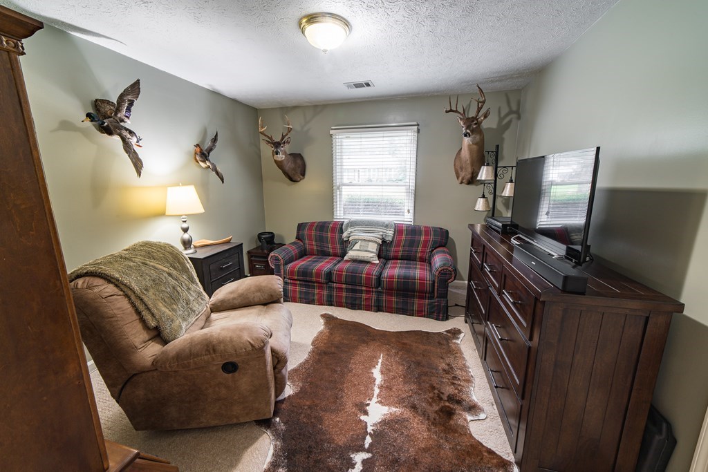 9 Conisburgh Court Columbus, GA 31907 - Photo 30 of 46 a living room with furniture a ceiling fan and a window