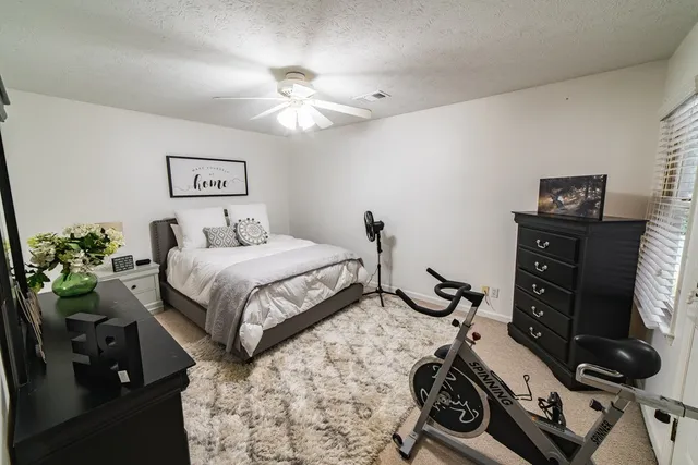 a bedroom with bed and potted plant