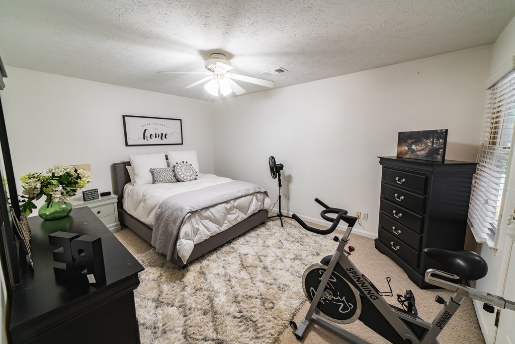 9 Conisburgh Court Columbus, GA 31907 - Photo 37 of 46 a bedroom with a bed and a chandelier