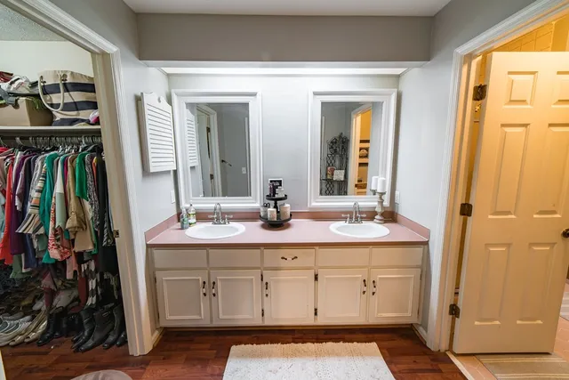 a bathroom with a tub sink and mirror
