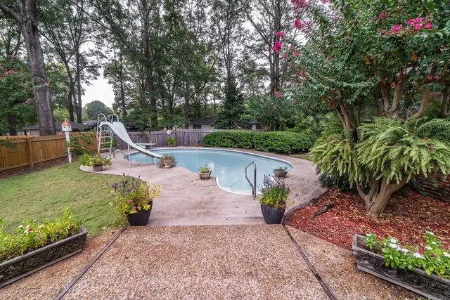 a view of a patio with couches table and chairs and potted plants