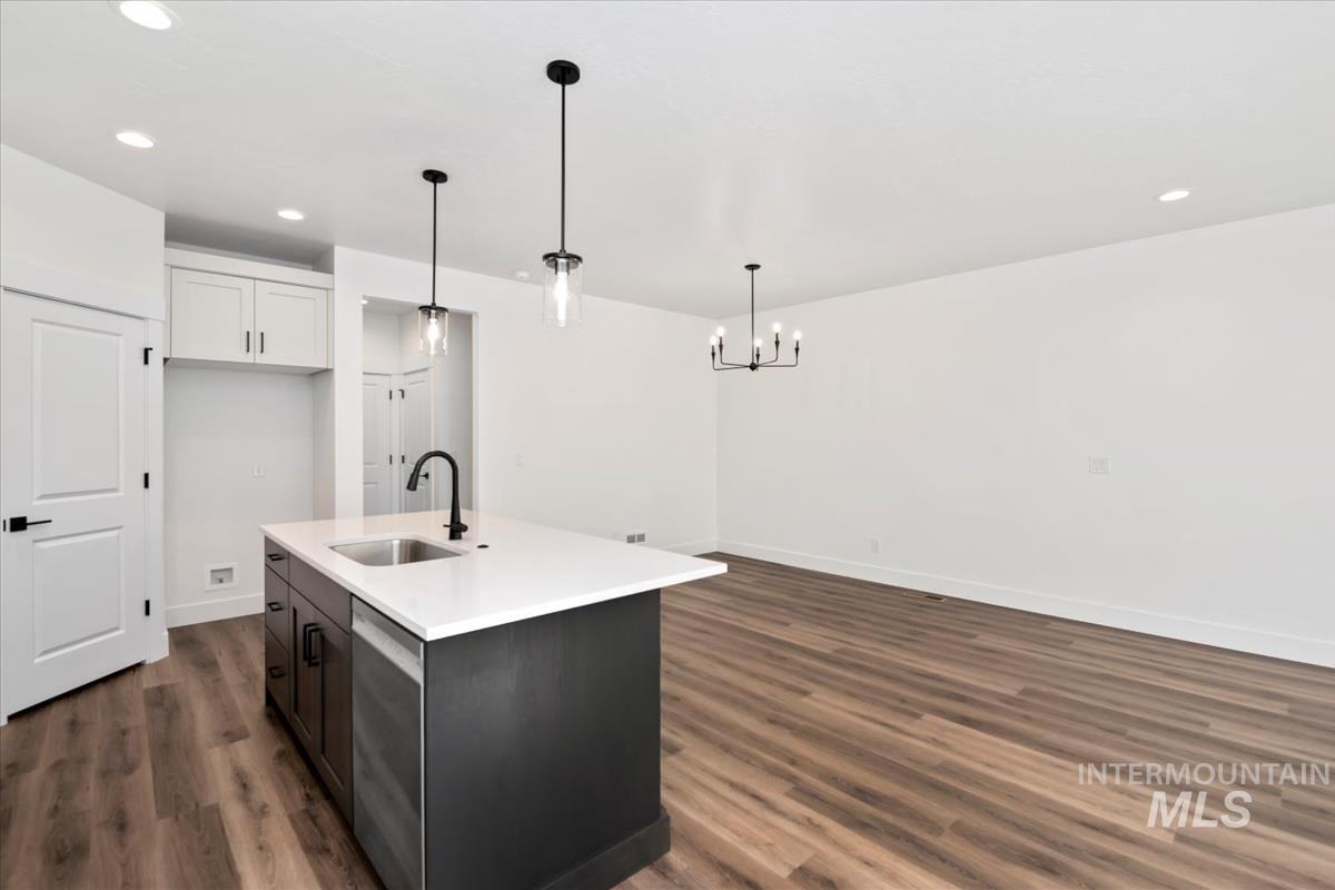752 South Calhoun Lane Star, ID 83669 - Photo 6 of 45 Kitchen island with white countertop, integrated sink, and matte black faucet