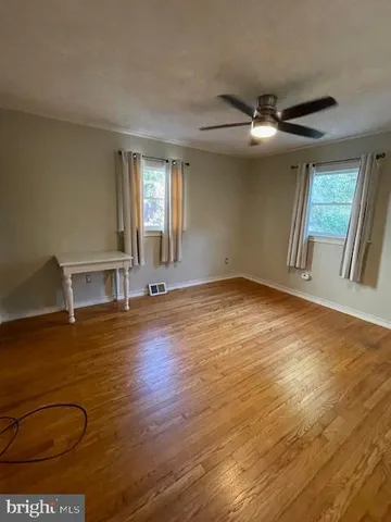 a view of a porch with furniture and potted plants