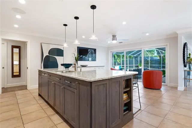 a kitchen with stainless steel appliances granite countertop a sink and a wooden floor