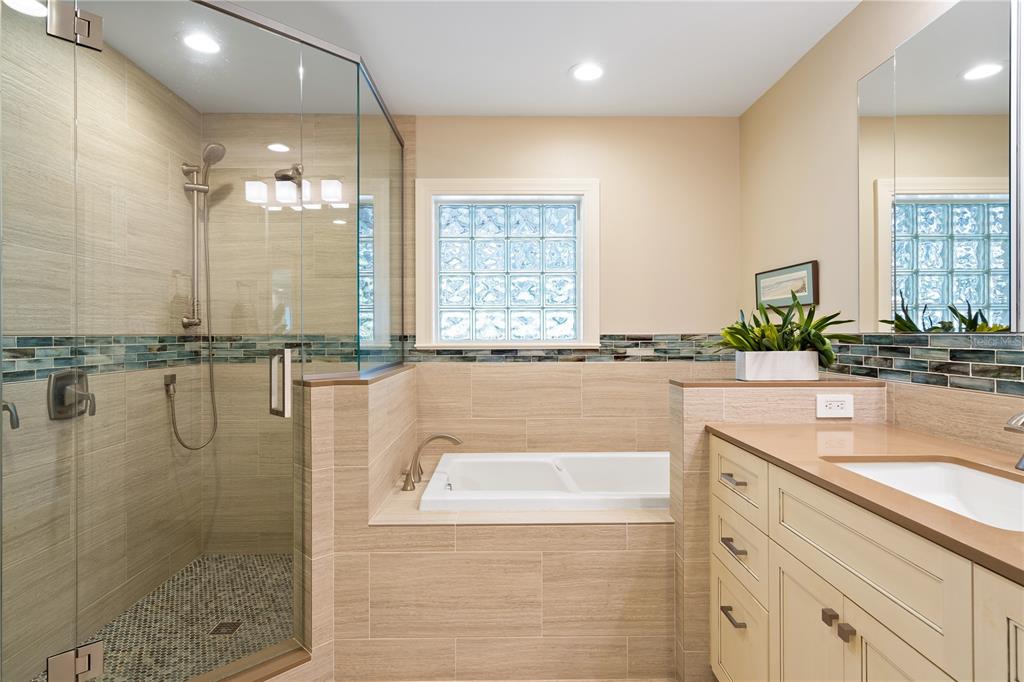 606 Owl Way Sarasota, FL 34236 - Photo 20 of 35 a bathroom with a granite countertop sink a mirror and a bathtub