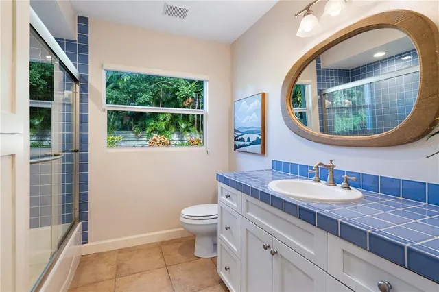 a bathroom with a sink a mirror and a toilet
