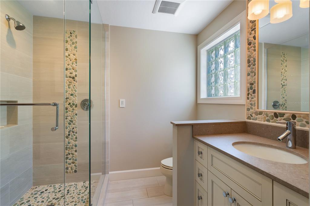 606 Owl Way Sarasota, FL 34236 - Photo 28 of 35 a bathroom with a shower sink and mirror