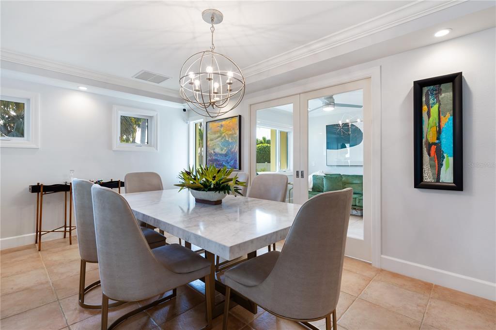606 Owl Way Sarasota, FL 34236 - Photo 8 of 35 a view of a dining room with furniture window and wooden floor