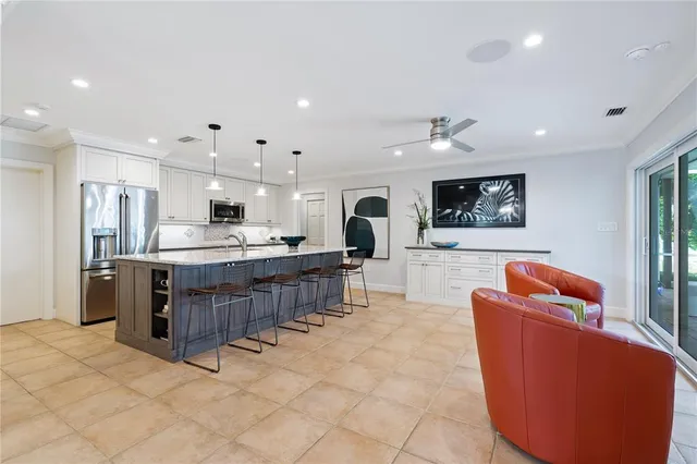 a living room with kitchen island furniture and a kitchen view