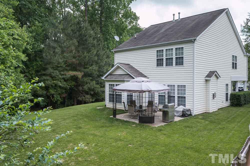 8437 Aztec Dawn Court Raleigh, NC 27613 - Photo 22 of 24 a view of a house with a yard and sitting area