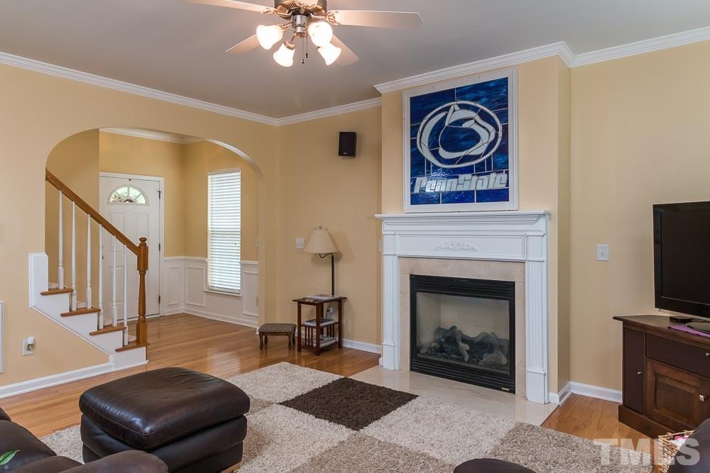 8437 Aztec Dawn Court Raleigh, NC 27613 - Photo 4 of 24 a living room with furniture and a fireplace
