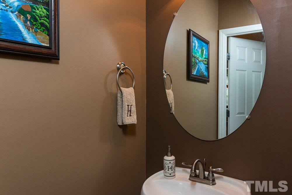 8437 Aztec Dawn Court Raleigh, NC 27613 - Photo 8 of 24 a bathroom with a sink and a mirror