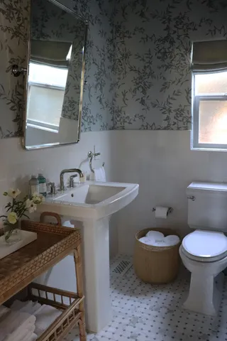 a bathroom with a sink toilet and mirror