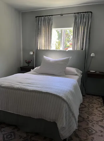 a bedroom with a bed and a window